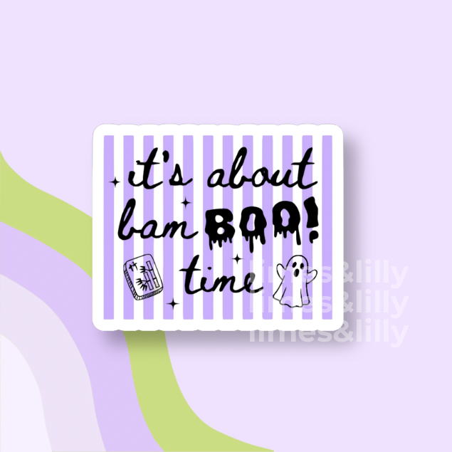 A rectangular sticker with rounded corners featuring a white border, lavender and white vertical stripes, and black text that reads 'it's about bam BOO! time' with small Halloween-themed doodles. The sticker is centered on a light lavender background with abstract green and purple curved shapes.
