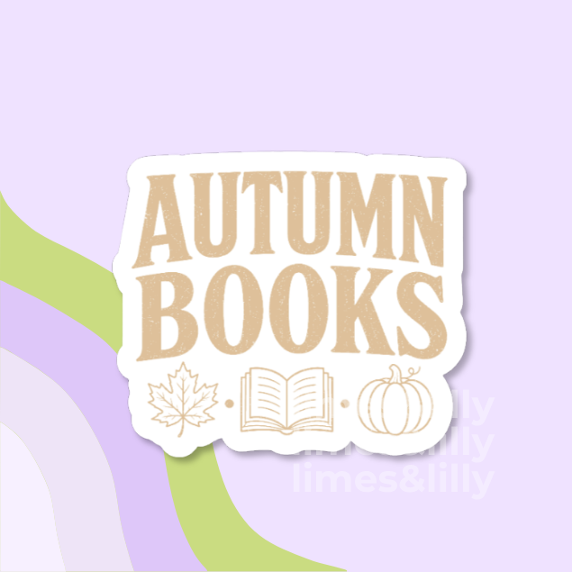 A die-cut sticker with the words 'AUTUMN BOOKS' in large tan letters on a white background, decorated with simple tan line drawings of a maple leaf, an open book, and a pumpkin. The sticker is centered on a light lavender background with abstract green and lavender curved shapes.