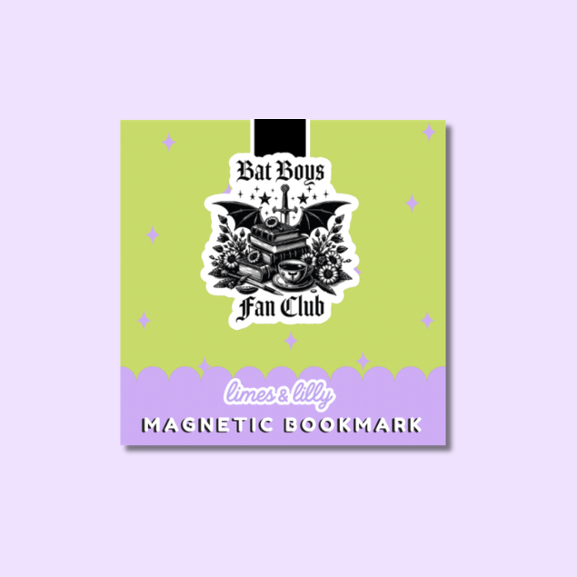 A square magnetic bookmark product shown on a light lavender background. The bookmark has a lime green upper section with small star accents, a black rectangular tab at the top, a central black-and-white illustrated emblem reading 'Bat Boys Fan Club,' and a lavender lower section with scalloped edge detail, white script text reading 'limes lilly,' and bold black text reading 'MAGNETIC BOOKMARK.