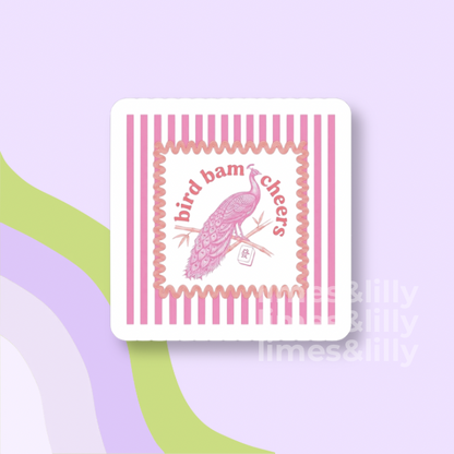Coaster with pink bird design and 'bird bam cheers' text on a light purple background