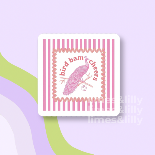 Coaster with pink bird design and 'bird bam cheers' text on a light purple background