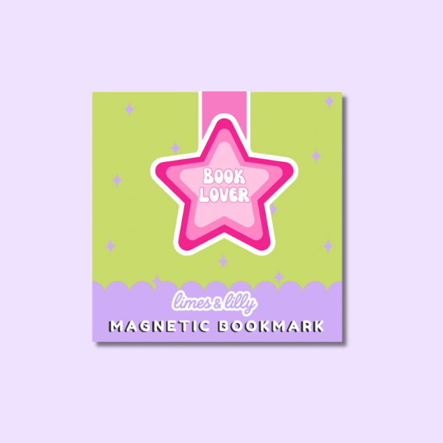 A square magnetic bookmark card with a pastel design, featuring a pink star outlined in white with the words 'BOOK LOVER' in the center, a pink ribbon graphic, and a lavender bottom border with the text 'limes & lily MAGNETIC BOOKMARK'. The product is centered on a light lavender background.