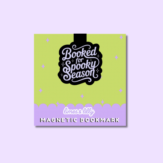 A square magnetic bookmark card with a lime green top section and a lavender bottom border, featuring the phrase 'Booked for Spooky Season' in white script inside a black shape. The bottom reads 'limes & lily' and 'MAGNETIC BOOKMARK'.