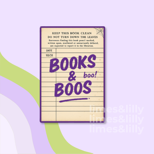 A decorative book-themed notepad with a purple border and lined cream paper, featuring the handwritten text 'BOOKS & boo! BOOS' in purple. The notepad is centered on a light lavender background with abstract green and purple curved shapes and a faint 'times&lilly' watermark.