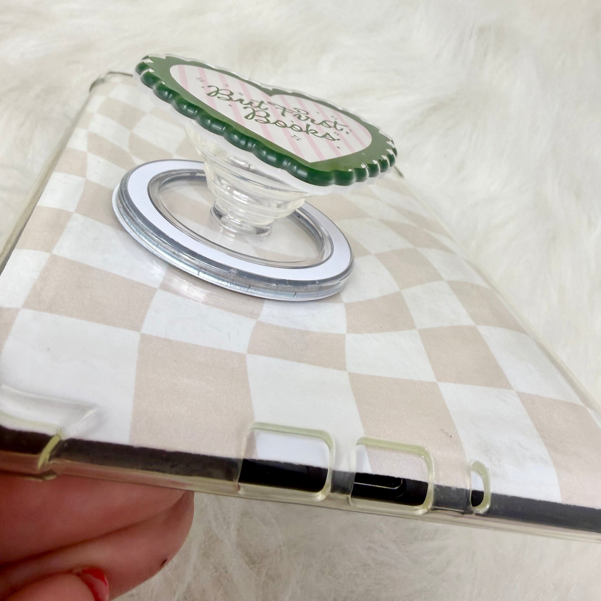 Clear phone case with a green and white logo on a checkered background
