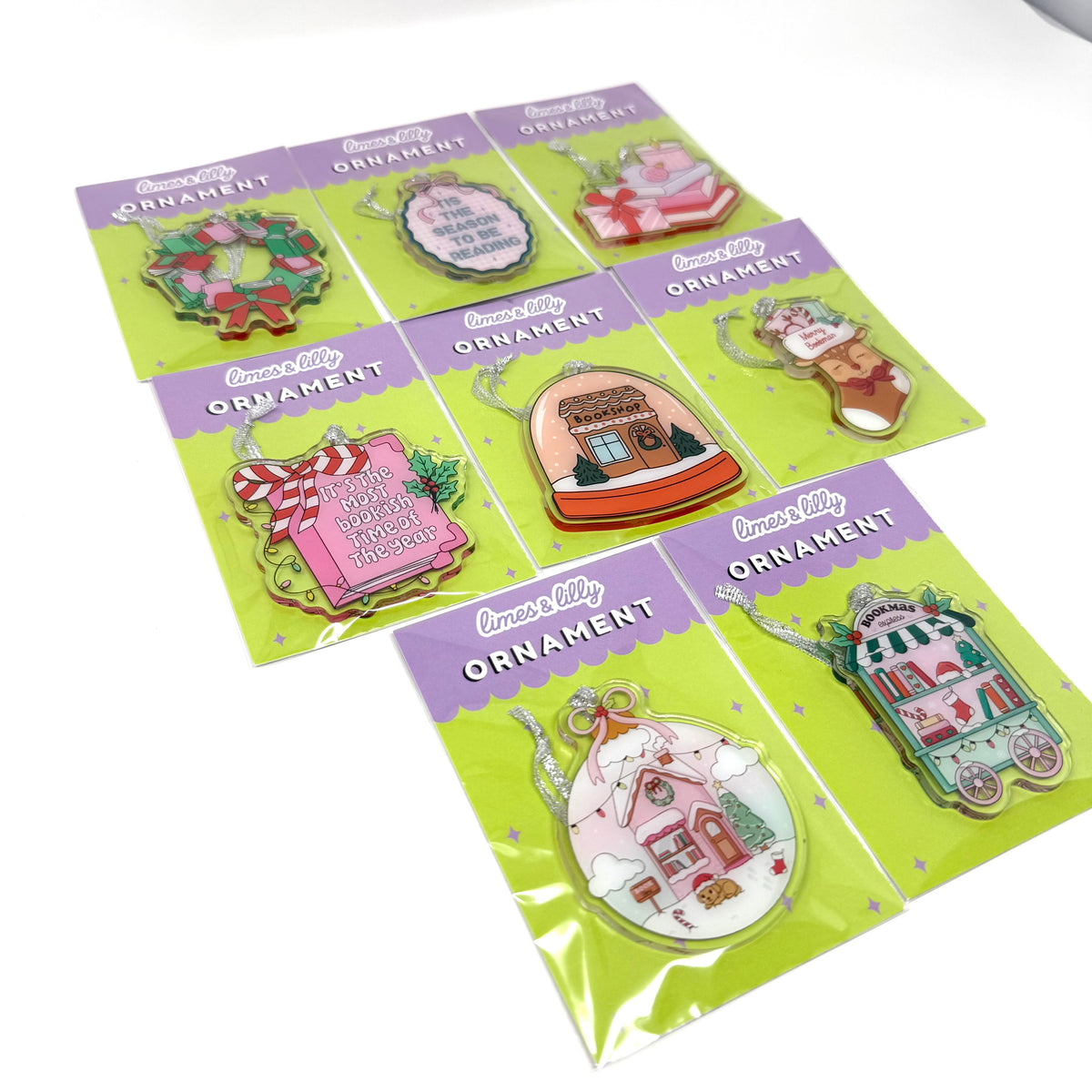 8 colorful enamel Christmas ornaments, each mounted on its own lime green card with a purple header that reads 'Cinnamoroll Ornament.' The cards are arranged on a white background.