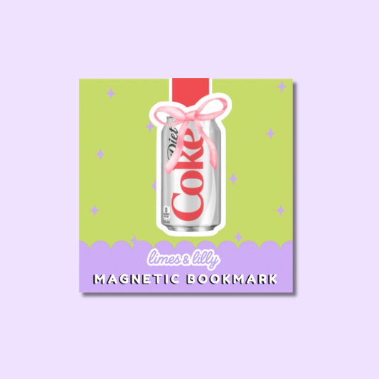 A square magnetic bookmark featuring a stylized limes lily design. The bookmark has a light green upper section with small purple star accents, a lavender bottom section with the text 'limes lily MAGNETIC BOOKMARK' in white, and a central illustration of a silver can with red lettering tied with a pink ribbon.