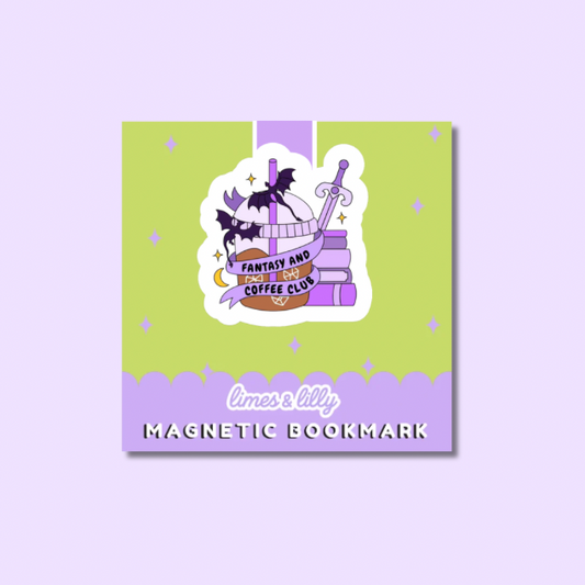 A square magnetic bookmark card with a whimsical illustration of stacked books, a sword, and a cat under a banner reading 'Fantasy and Coffee Club.' The card has a light green upper section, a lavender lower section, and the text 'limes & lily MAGNETIC BOOKMARK' at the bottom.