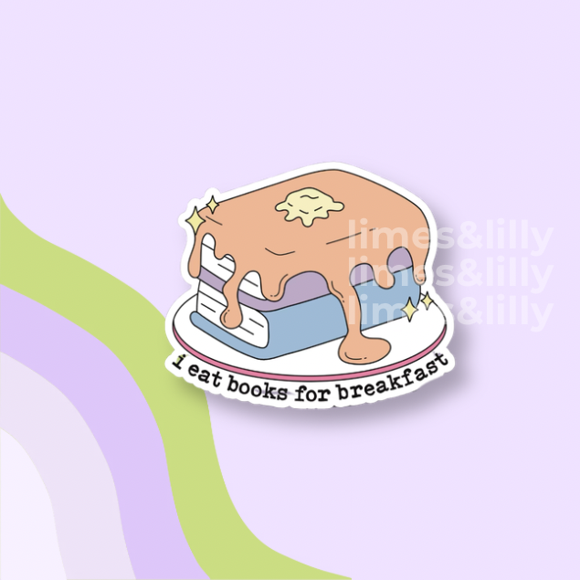 A die-cut sticker featuring a cartoon book covered in dripping frosting with the text 'I eat books for breakfast' on a light purple background with abstract green and lavender curved shapes.