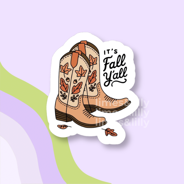 A die-cut sticker featuring a pair of tan western cowboy boots with orange and brown autumn leaves and the text 'IT'S Fall Yell' in black script, shown on a pastel lavender background with abstract green and purple curved shapes.