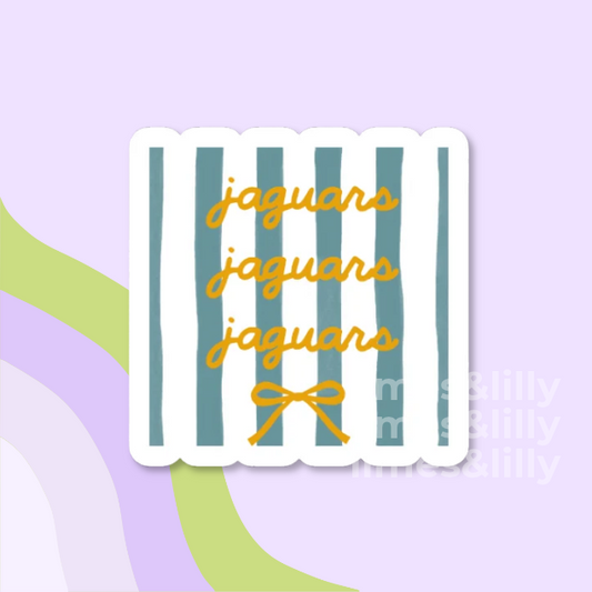 A die-cut sticker with a white background and vertical teal stripes, featuring the word 'jaguars' repeated in yellow script and a small yellow bow at the bottom, shown on a pastel lavender background with abstract green and lavender shapes.