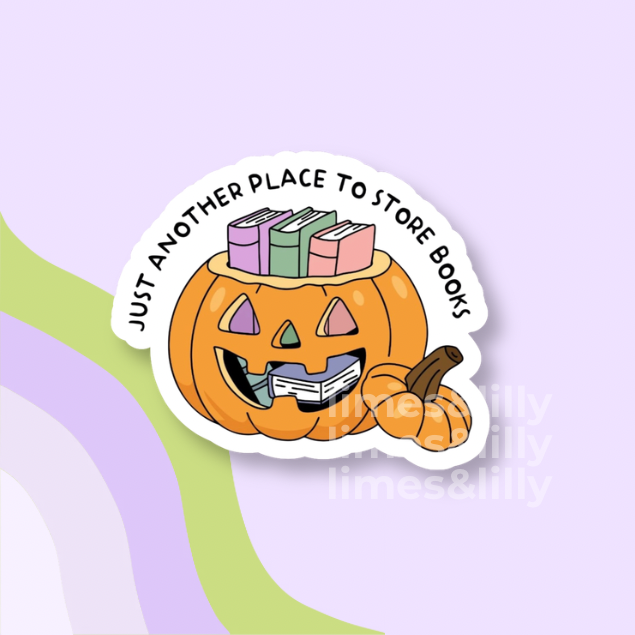 A die-cut sticker featuring a cartoon orange pumpkin with books on its head and a small pumpkin beside it, with the text 'JUST ANOTHER PLACE TO STORE BOOKS' curved above. The sticker is shown on a pastel lavender background with abstract green and lavender curved shapes.