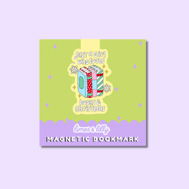 A die-cut sticker featuring a festive illustration with the text 'Coffee, Books & Christmas things.' The design shows a pink book with a green cover and Santa hat, next to a pink iced coffee cup with a candy cane straw, on a pastel lavender background.
