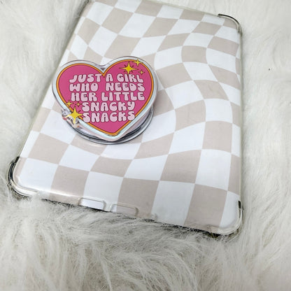 Checkered pouch with a heart-shaped pin on a fluffy surface
