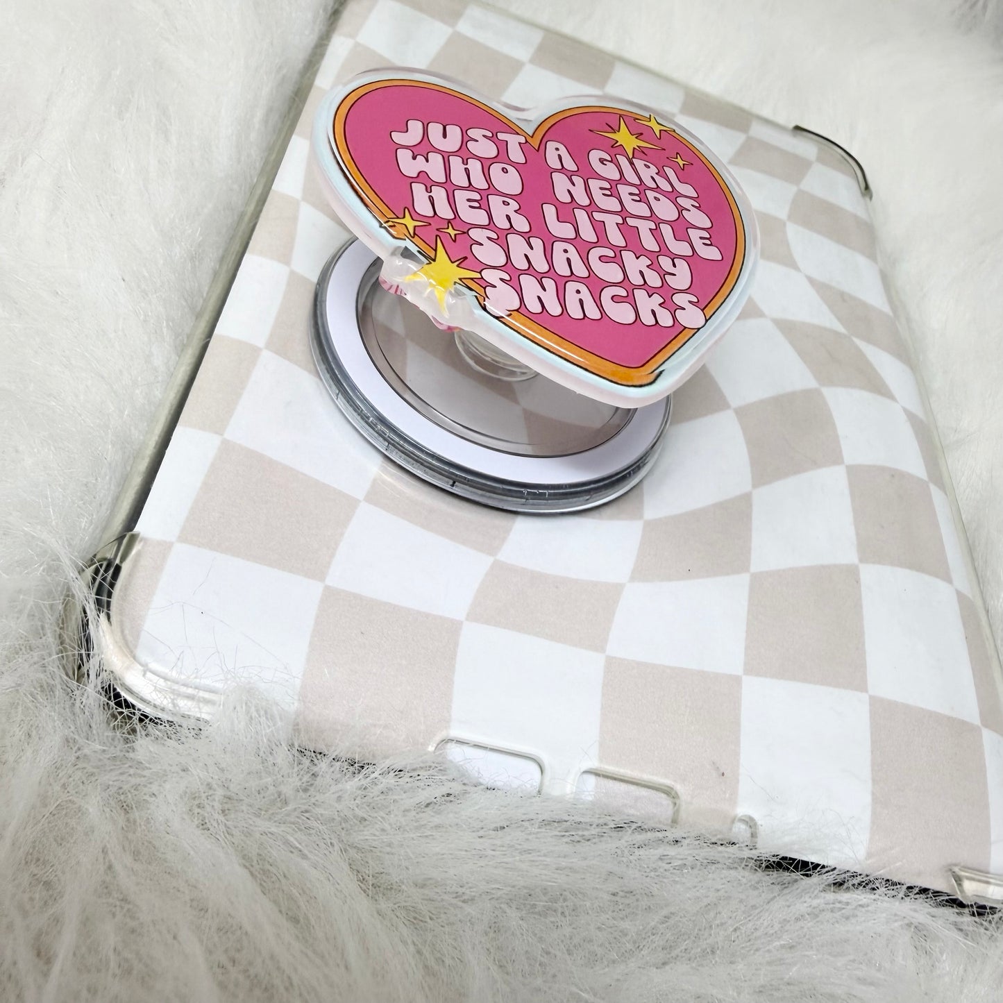 Heart-shaped snack container with a pink lid featuring text on a checkered background
