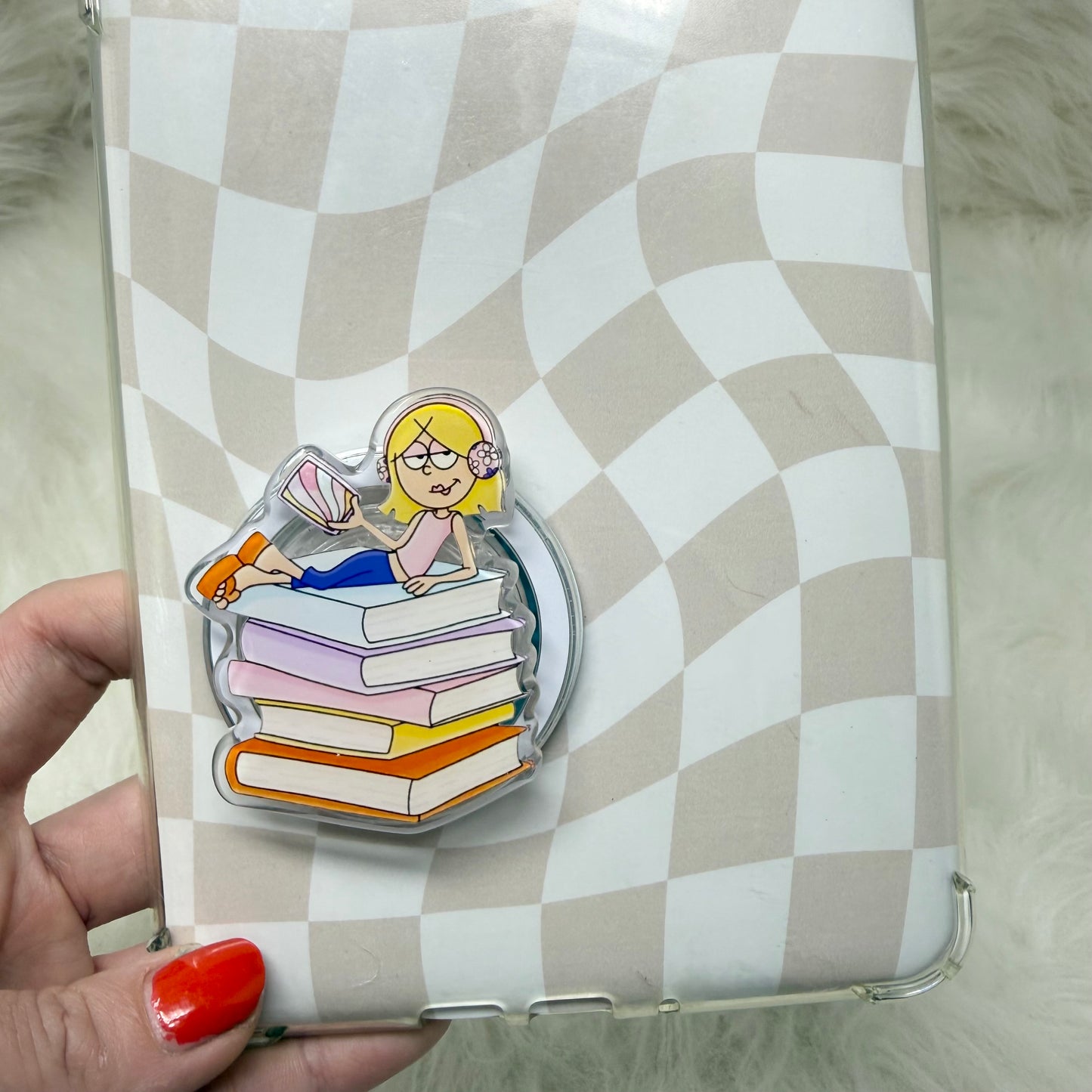 Phone case with a design of a person sitting on books against a checkered background