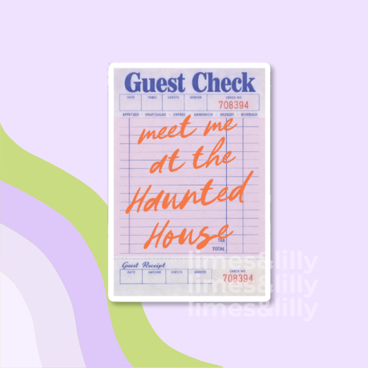 A guest check receipt card with blue printed fields, red transaction numbers, and orange script text reading 'meet me at the Haunted House,' shown on a pastel lavender background with abstract green and lavender curved shapes.