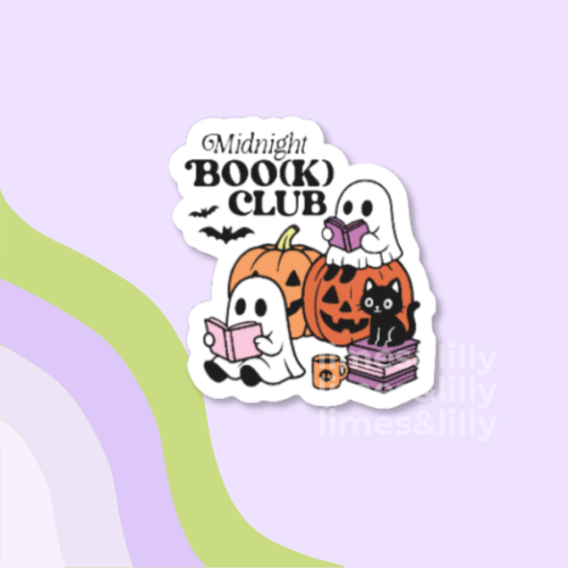 A die-cut sticker featuring a cute Halloween illustration with the text 'Midnight BOOK() CLUB'. The design shows white ghosts reading pink books, orange pumpkins, a black cat on purple books, and small bats, all on a light lavender background with abstract green and purple curved shapes.