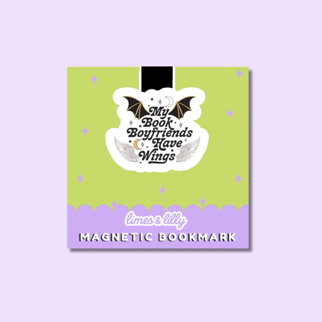 A square magnetic bookmark card with a lime green top half and lavender bottom border, featuring a white die-cut sticker that reads “My Book Boyfriends Have Wings” with bat and angel wings. The card is centered on a pale lavender background.