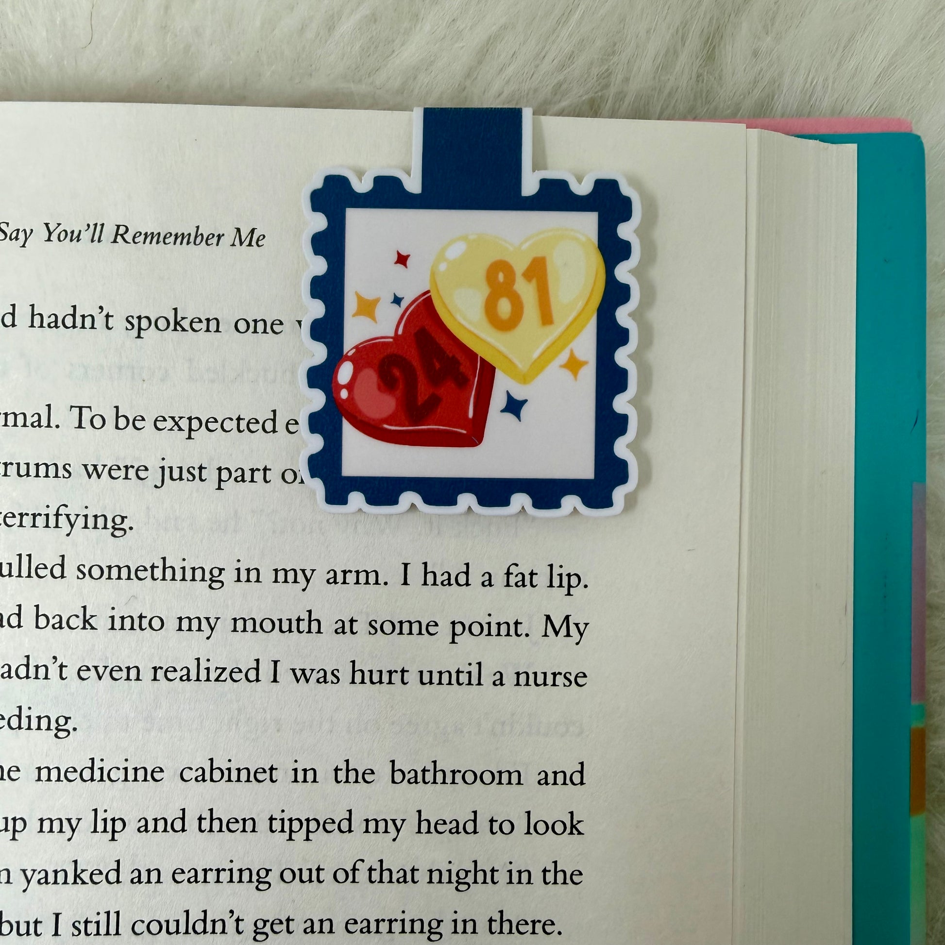 Book with a heart and number 81 sticker on a wooden surface