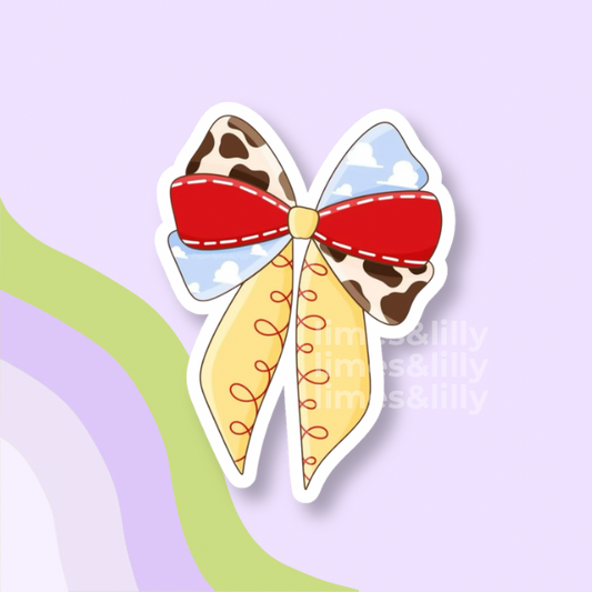 Colorful bow with red center, yellow sides, and cow print on a light purple background