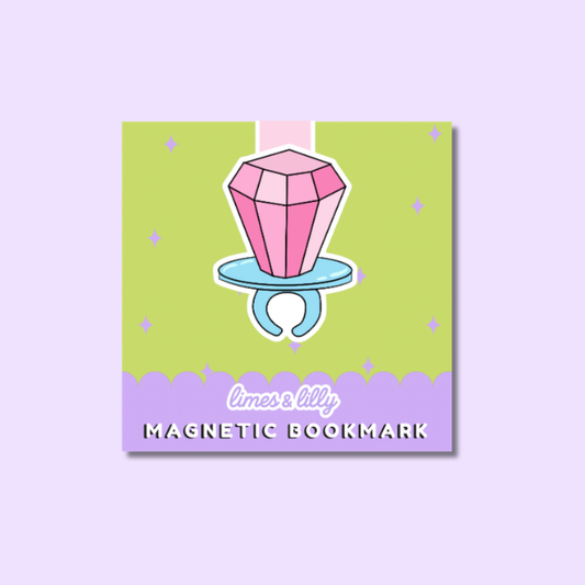A square product card for a magnetic bookmark featuring an illustrated stack of books with autumn leaves and the title 'Soda Shoppe,' plus the text 'limes & lilys' and 'MAGNETIC BOOKMARK.' The card is centered on a pale lavender background.