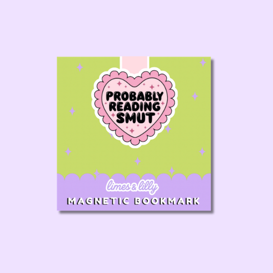 A square product card for a magnetic bookmark. The card features a lime green top section with a pink heart-shaped sticker that reads 'PROBABLY READING SMUT' in black text, and a lavender bottom section with the text 'limes & lily MAGNETIC BOOKMARK'.