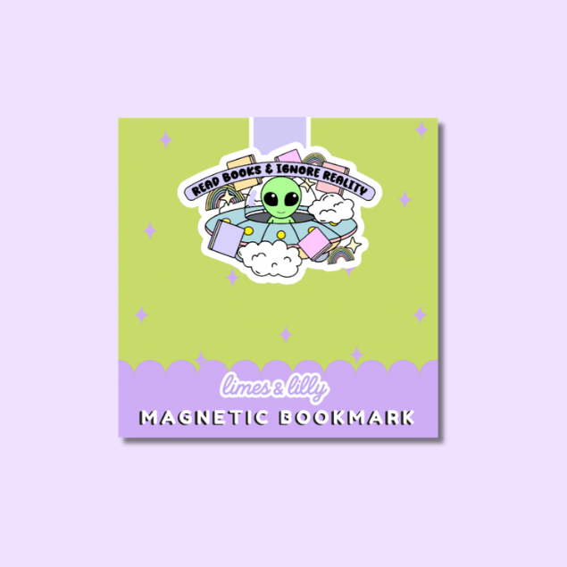 A square product card for a magnetic bookmark featuring a cartoon alien in a UFO with books, on a lime green and lavender background. The text reads 'READ BOOKS & IGNORE REALITY' and 'limes & lily MAGNETIC BOOKMARK'.