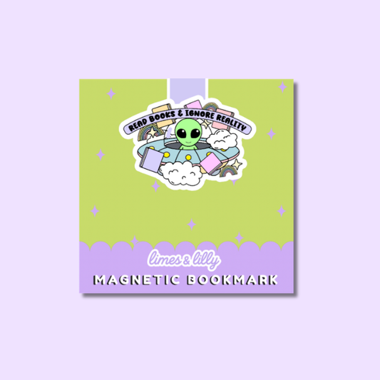 A square product card for a magnetic bookmark featuring a cartoon alien in a UFO with books, on a lime green and lavender background. The text reads 'READ BOOKS & IGNORE REALITY' and 'limes & lily MAGNETIC BOOKMARK'.