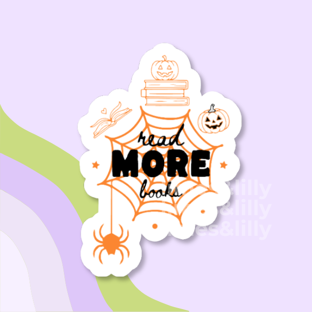 A die-cut sticker with a white border featuring Halloween-themed illustrations and the text 'read MORE books' in black and orange, shown on a pastel purple background with abstract green and lavender curved shapes.