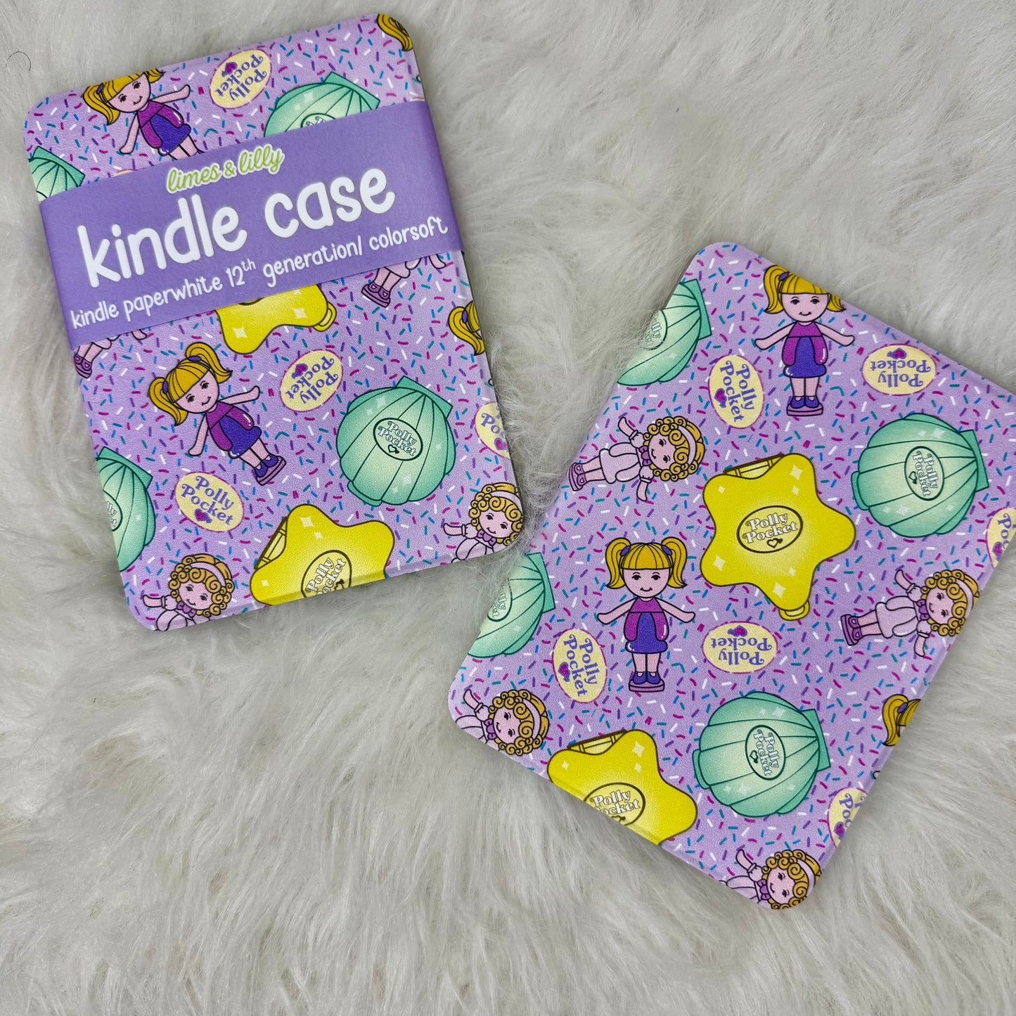 Purple kindle case with colorful design on a white fluffy surface