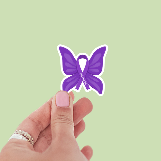Hand holding a purple butterfly with a ribbon on a light green background