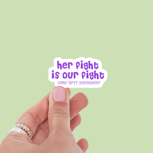 Hand holding a sticker with 'her fight is our fight' text on a light green background
