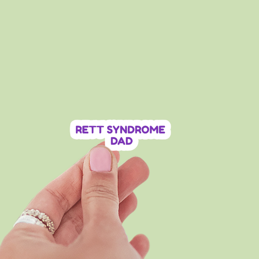 Hand with pink nail polish on a light green background with 'RETT SYNDROME DAD' text.