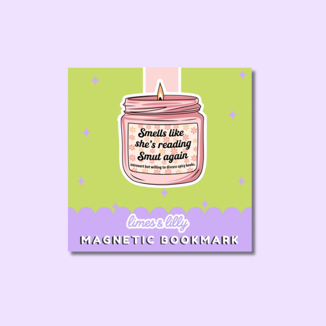 A square magnetic bookmark card featuring a pink candle jar illustration with the phrase 'Smells like she's reading Smut again' and 'limes & lily MAGNETIC BOOKMARK' on a light purple background.