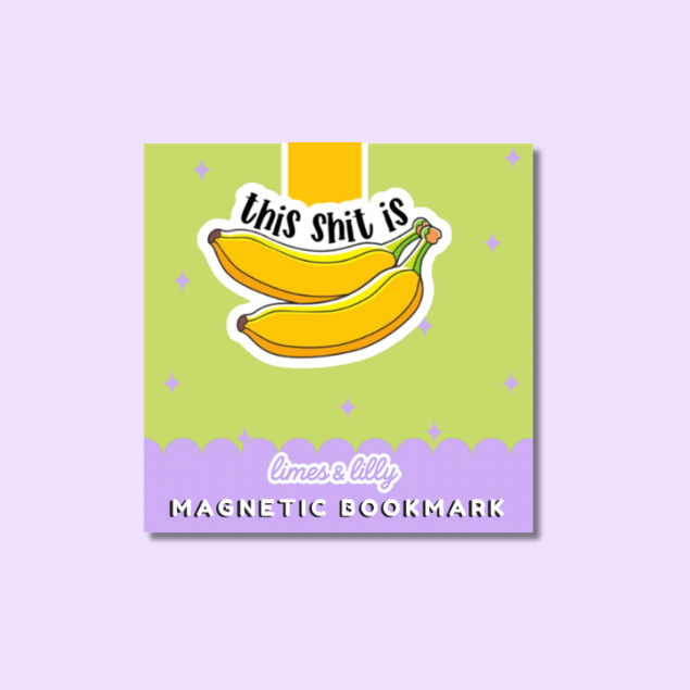 A square magnetic bookmark with a light green face, a purple scalloped bottom border, and an illustration of two yellow bananas with the text 'this shit is'. The brand name 'limes & lily' is printed on the purple border, and the product is shown against a light lavender background.