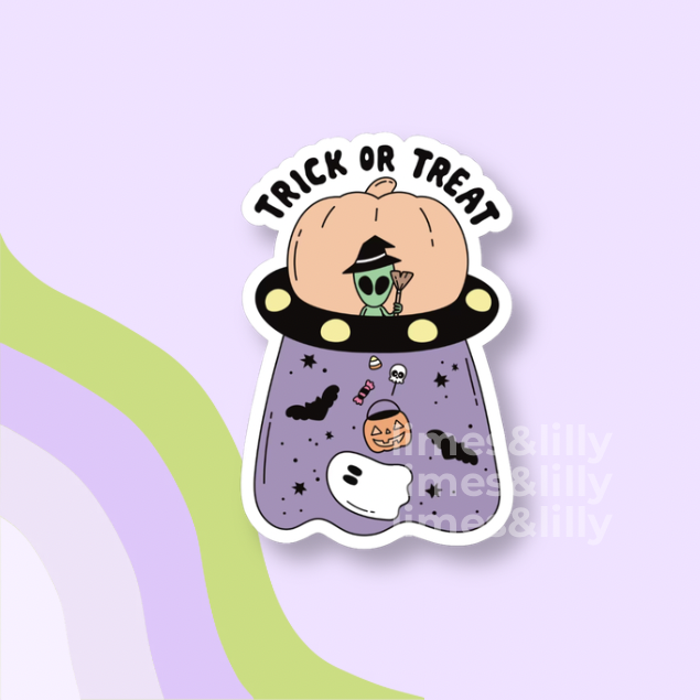 A die-cut sticker featuring a cartoon pumpkin with a green alien wearing a witch hat, floating in a purple UFO with the words 'TRICK OR TREAT' above it. The sticker is shown on a pastel purple background with abstract wavy stripes in green and lavender.
