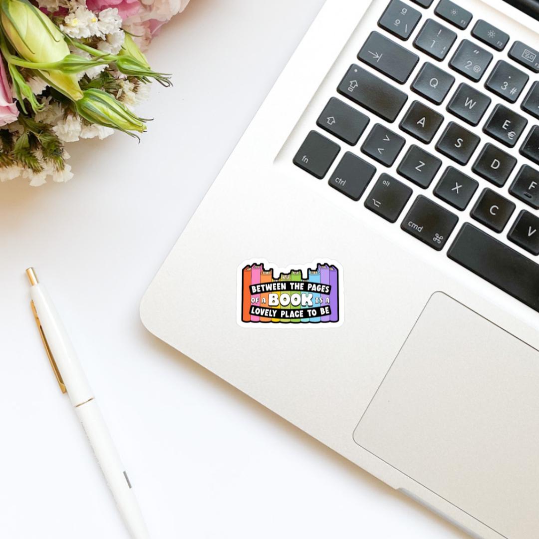 Between the Pages of a Book is a Lovely Placd to Be Book Stack Sticker | bookish stickers, book lover, book stickers, kindle, laptop